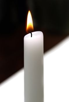 A flame infront of a black and white background to represent unity.