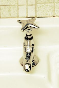 A retro bathroom sink tap.