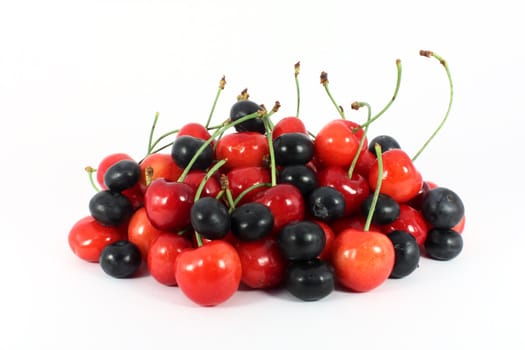 Heap of sweet cherries and blueberries isolated on white