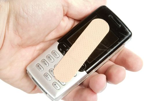A cell phone with an adhesive bandage being held in a males hand, isolated on white with clipping path.