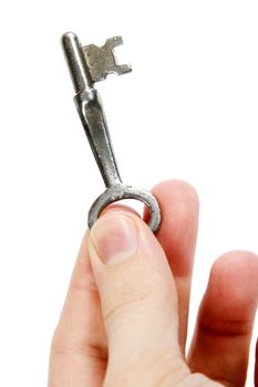 An old skeleton key being held by a male's hand.  Isolated on white with clipping path.