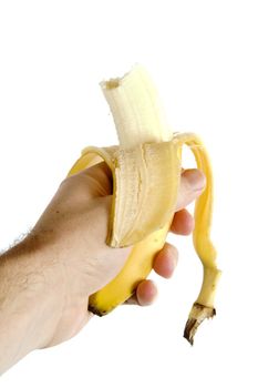 A half eaten banana being held in a hand.  Isolated on white with clipping path.