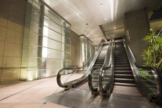 escalators in a building in hong kong at night