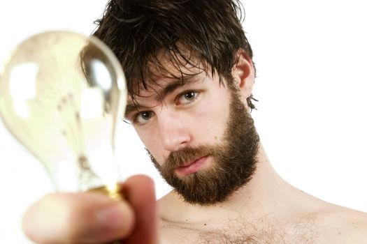 A humor shot, of a young newly showered male, holding a light bulb, thinking up fresh new ideas.