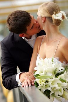 Close up of newlywed couple kissing on wedding day.