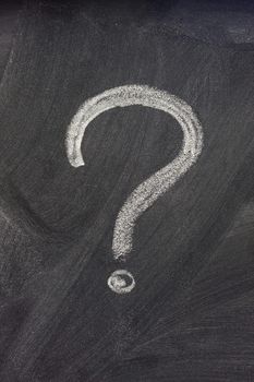 question mark handwritten with a white chalk on on a blackboard