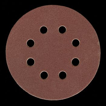 all purpose, fine grit, adhesive backed sanding disk with venting holes on black background