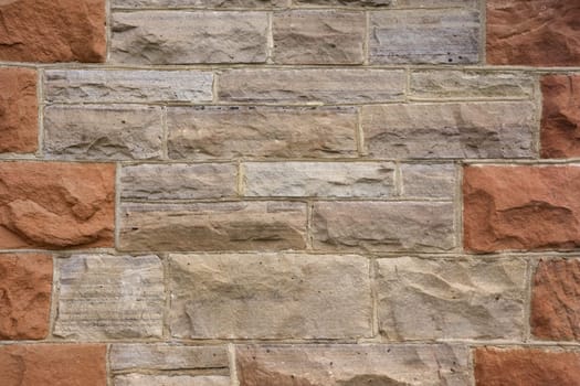 old gray and red sandstone wall from a 19th century historical house