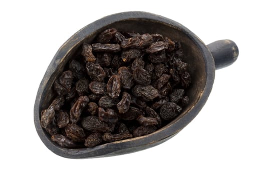 raisins on a primitive, wood sccop, isolated with clipping path