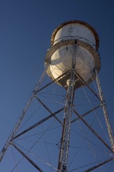 Old abandoned water tower against blue sky in a small southwester town, a typical construction which was used across the United States.
