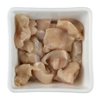 white, square bowl with chicken breast sliced for stir fry; isolated with clipping path
