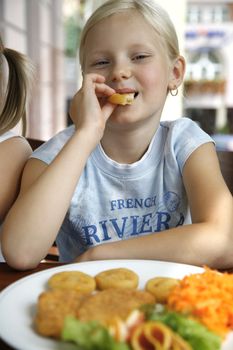 little girl them lunch in a restaurant