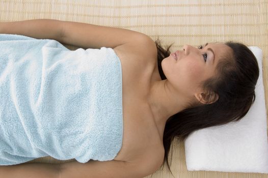 young woman in relaxation pose after taking massage