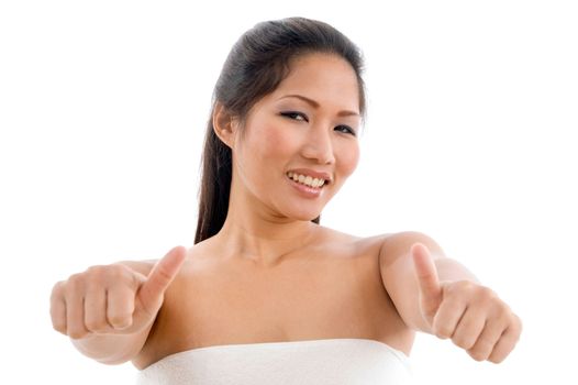 young woman in towel showing thumb up with white background