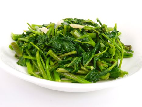 Fried spinach cabbage. Close up on white background