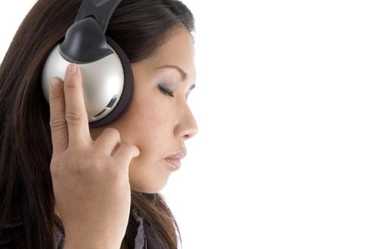 asian, chinese, japanese, korean, asian pacific, thai  woman concentrating on music against white background