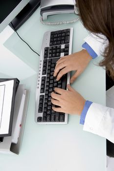 doctor's hand on keyboard in clinic
