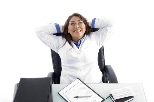 cheerful female doctor looking upward against white background