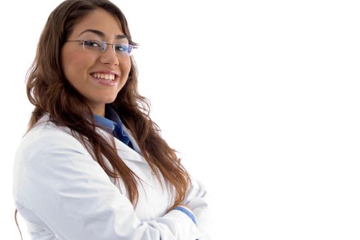 smiling doctor posing with folded arms against white background