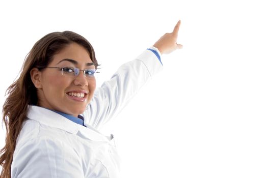 smiling female pointing with finger on an isolated white background