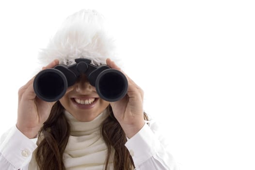 woman in winter wear watching through binocular with white background