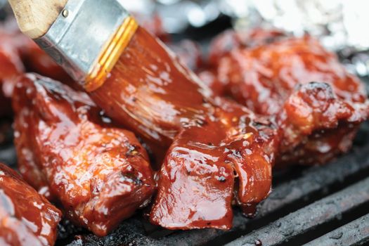 Barbecue beef ribs on the grill. Extreme shallow DOF with selective focus on center rib.