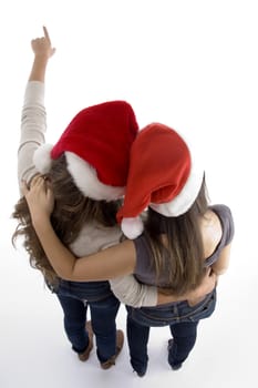 friends in christmas hats pointing backwards with white background