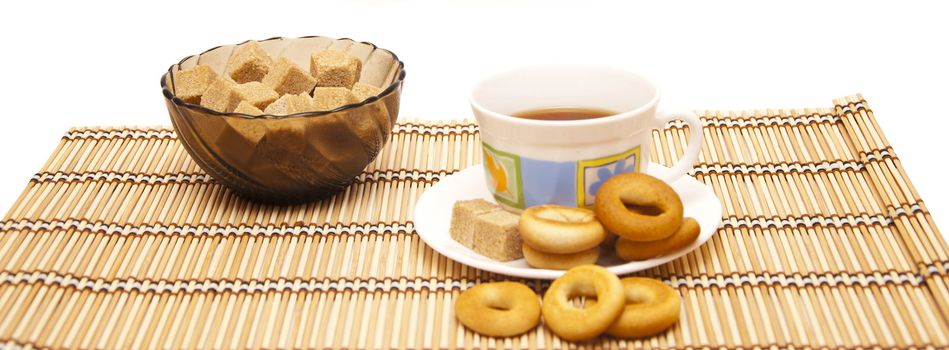 Cup of tea with steering-wheels on straw rug