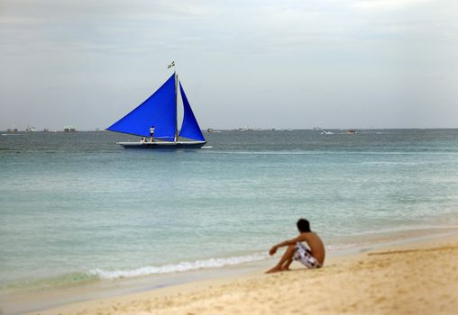 The lonely boy on a coast of silent ocean