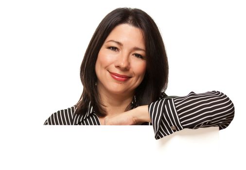 Attractive Multiethnic Woman Resting Arm Behind Blank Sign Corner Isolated on a White Background.