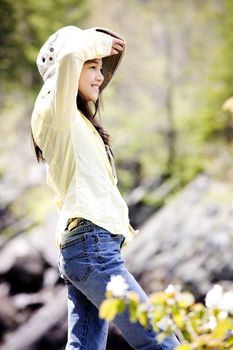 Girl standing on mountain shading eyes, looking around