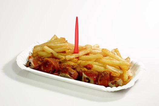 German currywurst with ketchup and french fries on bright background
