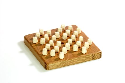 Wooden solitaire game on bright background
