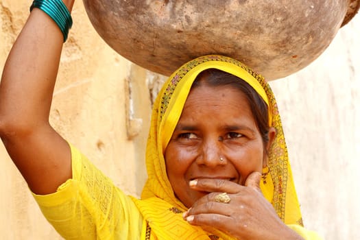 Woman wearing a yellow sari - India