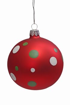Red christmas tree ball with spots, isolated on white background