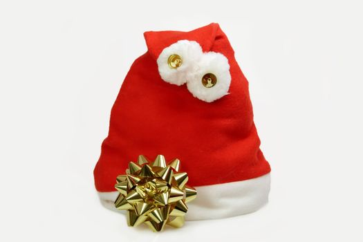 Santa Claus hat with golden robbon on light background