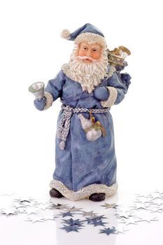 Blue Santa Claus figure with silver stars on light background