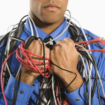 African American businessman wrapped in computer cables.