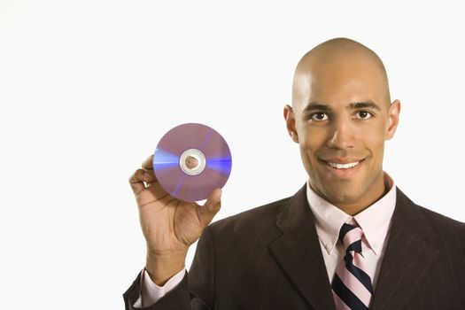 African American man smiling holding out compact disc.