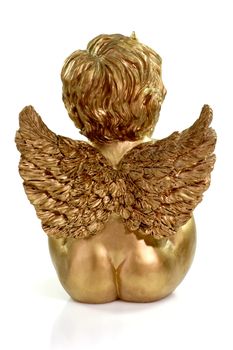 Backside of a golden angel figurine on bright background