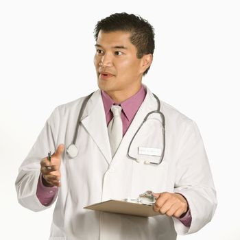 Asian American male doctor holding clipboard talking and gesturing.