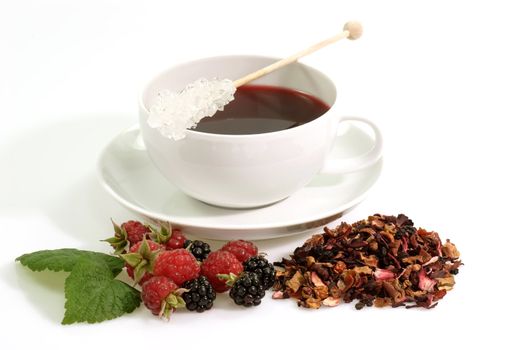 A cup of red fruit tea on bright background