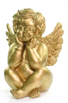 Figurine of a dreaming cherub on bright background