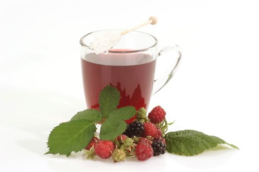 A glass of red fruit tea on bright background