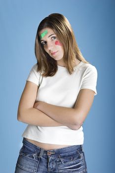 Beautiful woman with colored bandages on the face over a blue background