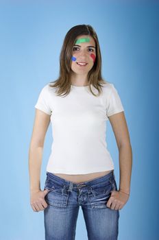 Beautiful woman with colored bandages on the face over a blue background