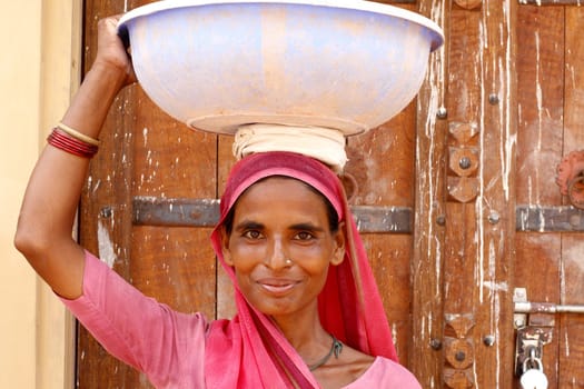 Old woman wearing a beautifully embroidered sari