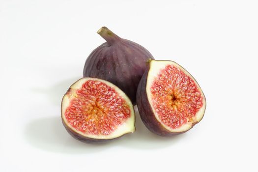 Two fres and ripe figs on bright background