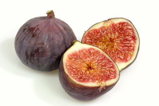 Two ripe fres figs on bright background