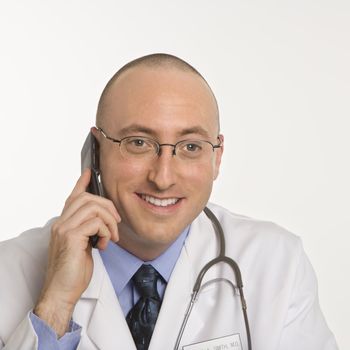 Caucasian mid adult male physician talking on cellphone.